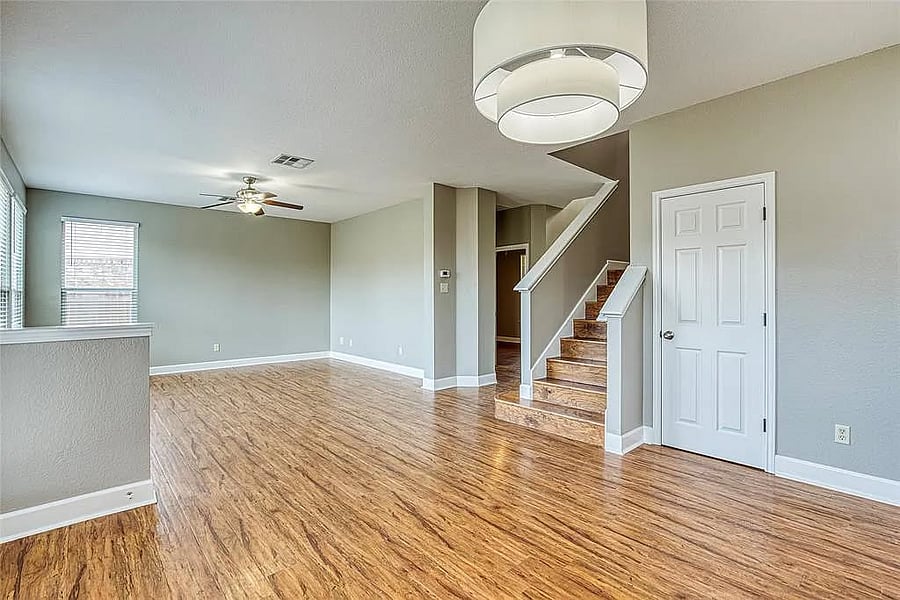 Open concept living room connected to kitchen. Will be furnished. View of secondary room and entryway to far right