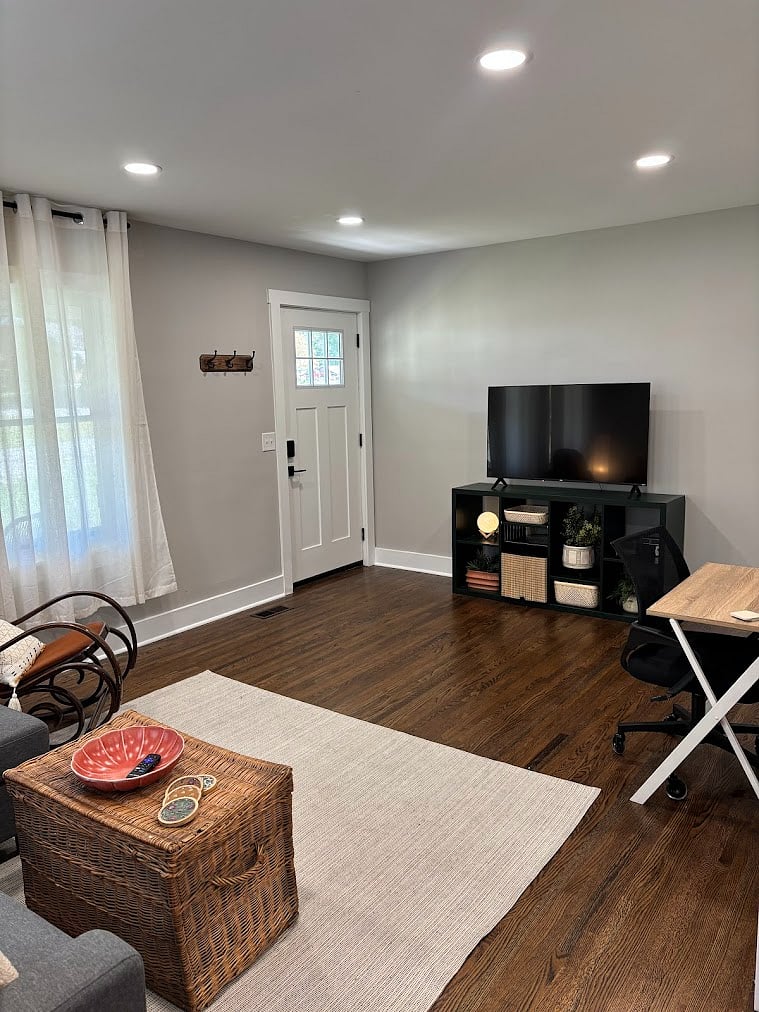 living room with smart tv and work desk