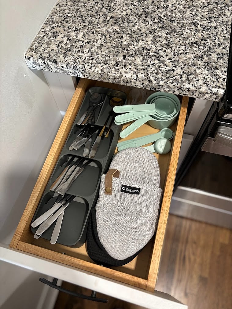 silverware, measuring cups, oven mitts