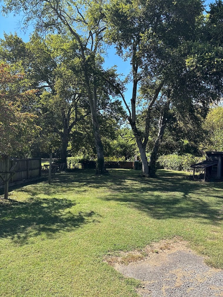 large, fenced yard with swings