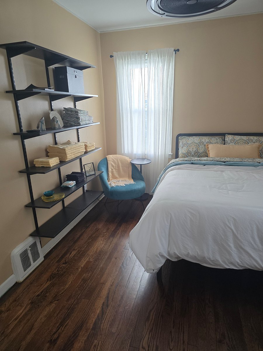 Shelving, extra linens, chair, side table.