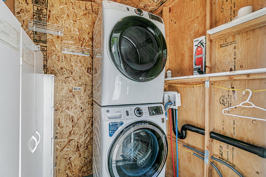 1 bed, 1 bath space. Newer permitted laundry space with light and storage.