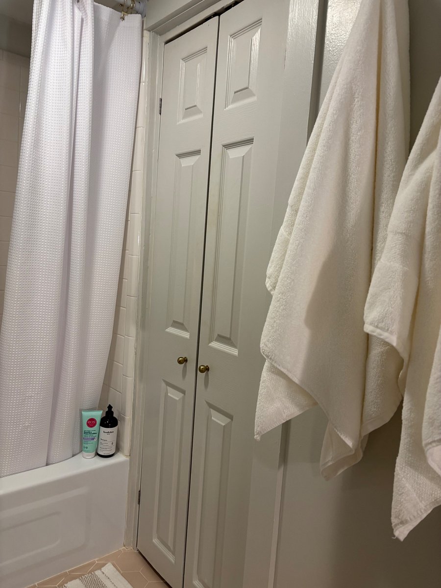 2nd floor bathroom has a partial walk-in closet with shelves for linens. 