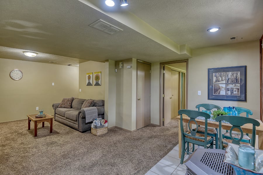 Spacious 945 ft home with room to relax, entertain, or work, featuring cozy seating and a warm, inviting atmosphere with Sackcloth & Ashes throw blankets throughout.