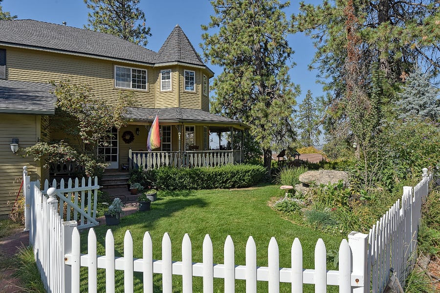 Approaching along the quiet street, the charming main house with its castle-like presence, white picket fence, and wrap-around porch sets the scene. Just beyond, your secluded private parking and separate entrance welcome you to an independent, peaceful retreat.
