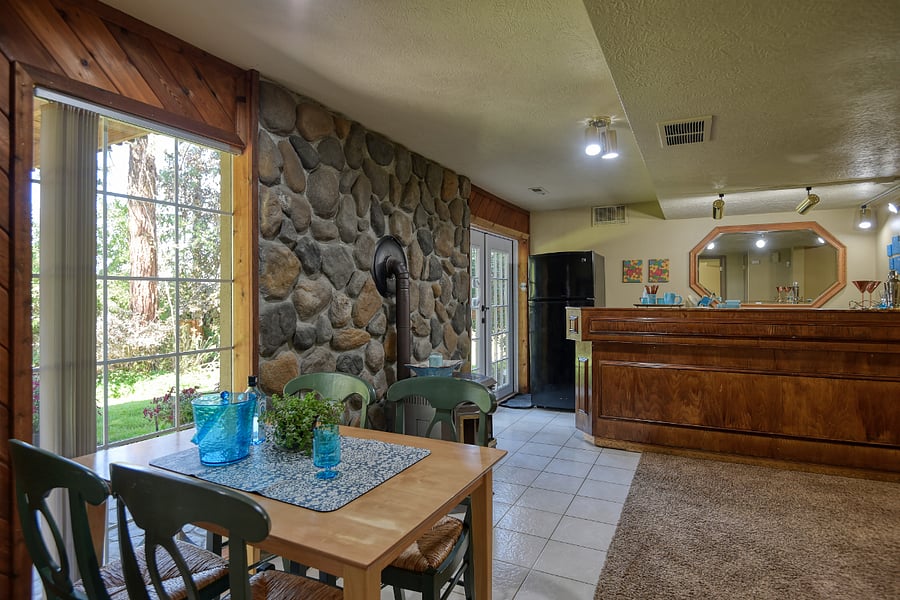 Vibrant dining table for four, perfect for meals, remote work, or creative projects. Colorful chairs and comfy wicker seats bring warmth and added personality to the space.