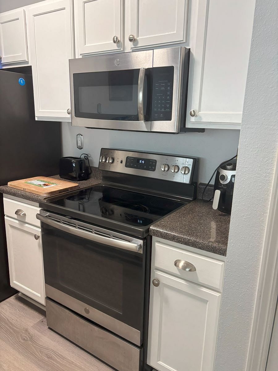 Fully-stocked kitchen including stove, microwave, toaster, crockpot, fridge & dishwasher