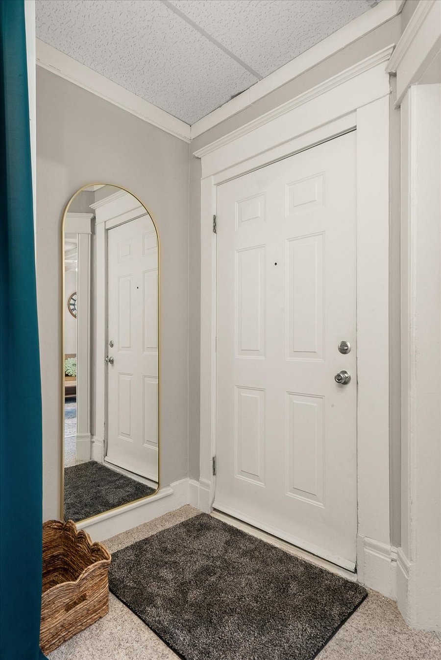 front door entry with full-length mirror