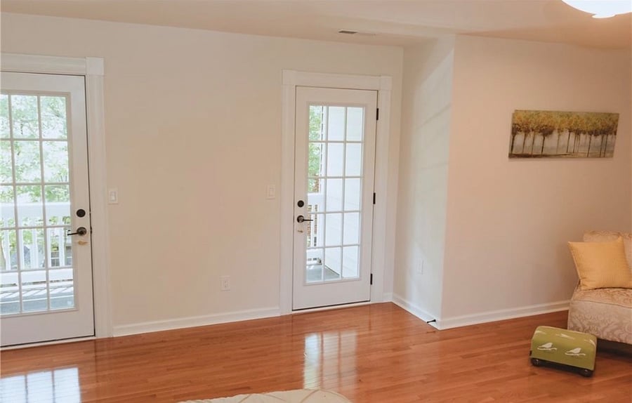 French doors in primary bedroom leading to private balcony.