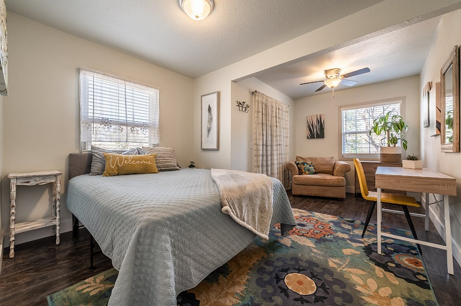Bedroom with Q sized bed, work station and reading nook