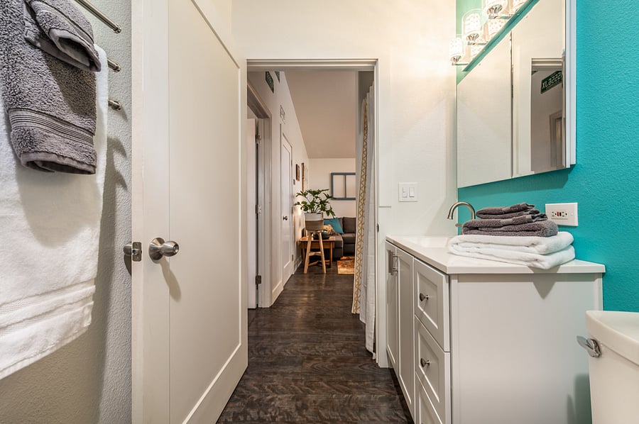 Full sized bathroom with walk in shower and plenty of storage