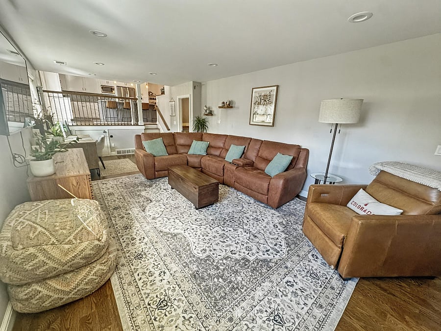 Main living Room. 65" Smart TV with Youtube TV Provided (including ESPN/Redzone). Comfy, oversized reclining sectional with cup holders.