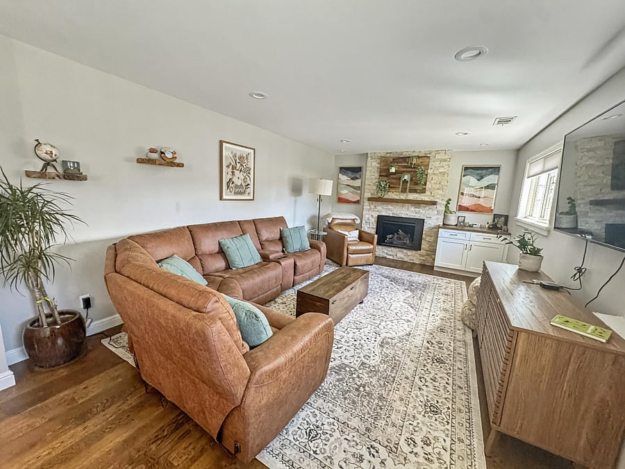 Large Reclining couch with 3 reclining sections. Corner reading chair/recliner. Indoor gas fireplace. 