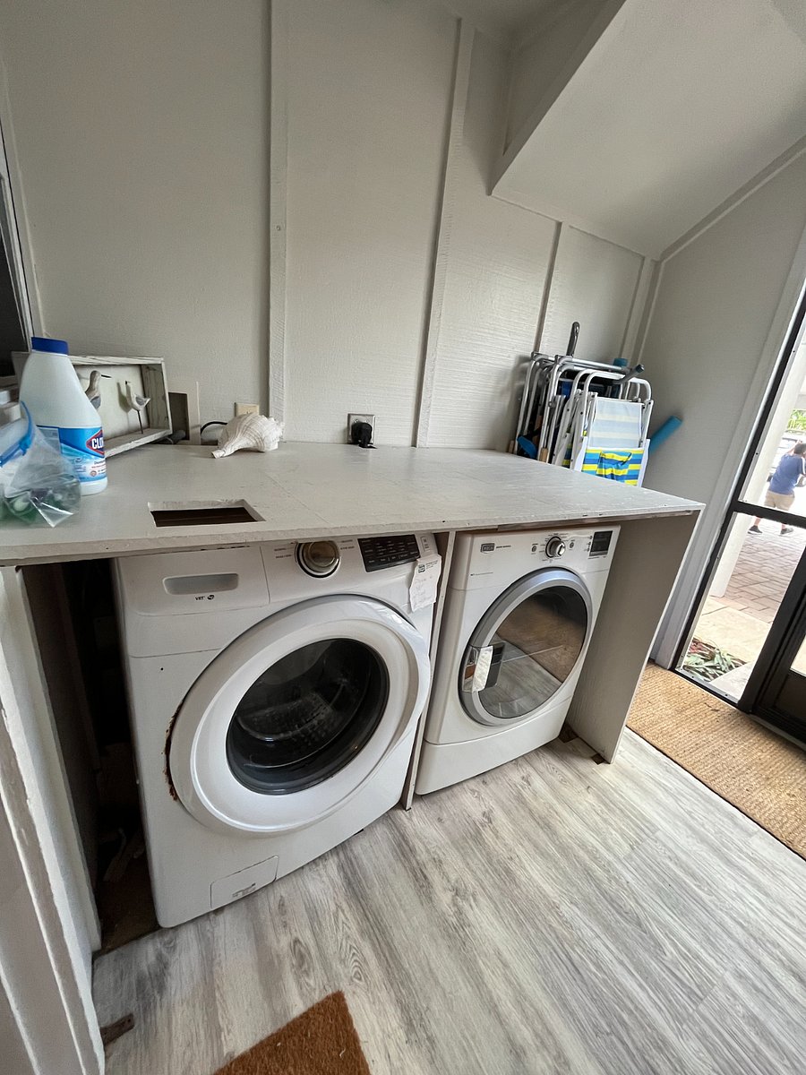 Full-size washer and dryer located on the front screen porch.