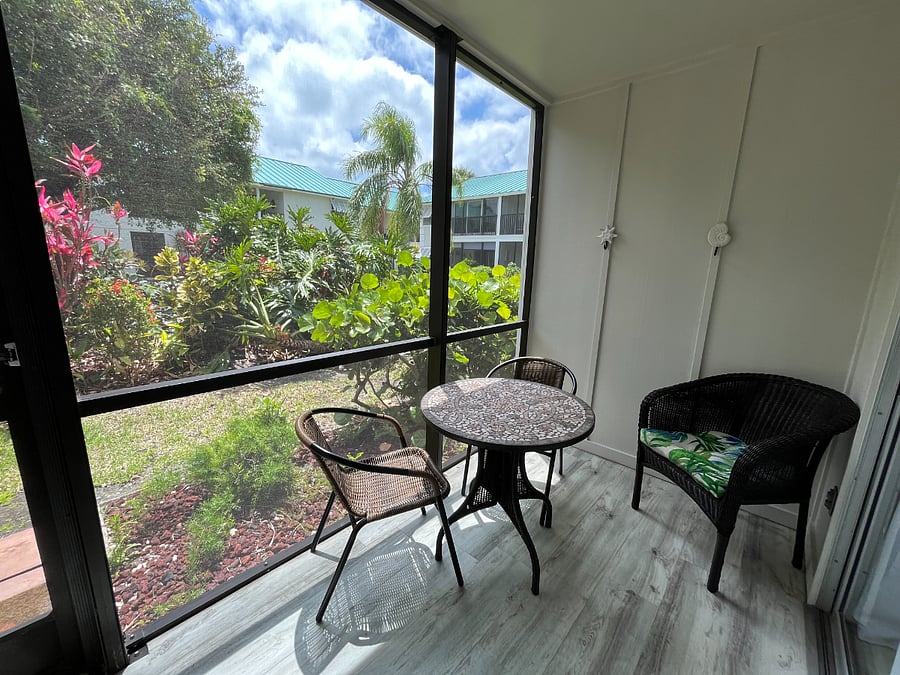 Screened in patio, looks over our beautiful common area with BBQS and tables.