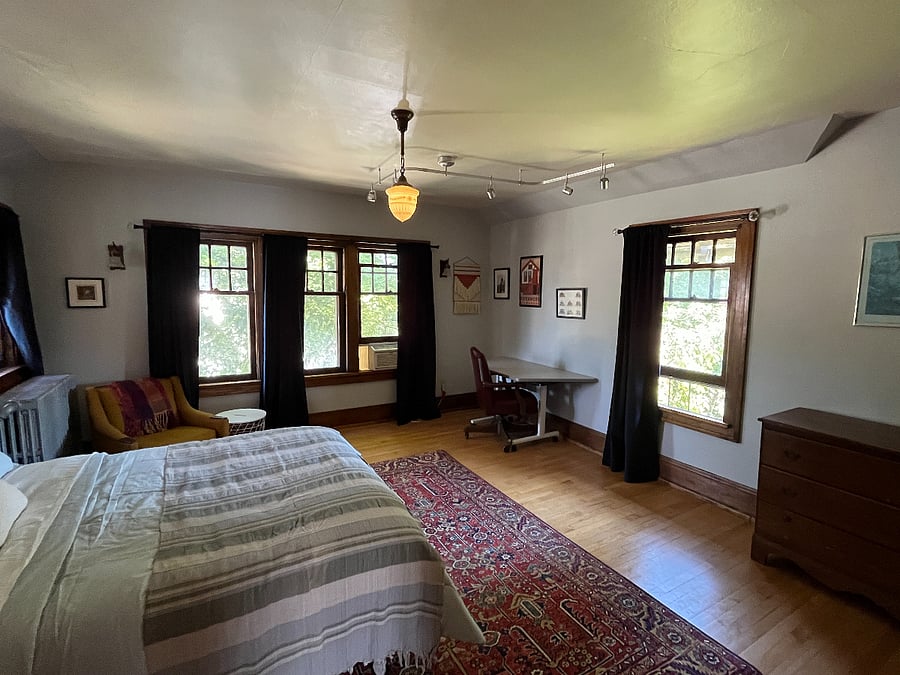 Bedroom 1 - Sunny bedroom with three walls with windows. Blackout curtains installed for ultimate dark at night.