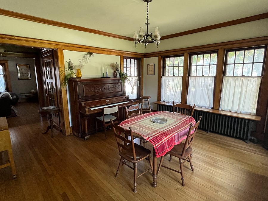 Dining room with beautiful woodwork and antique upright piano
