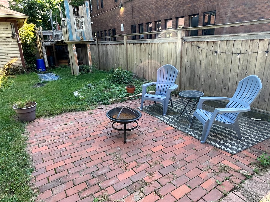 Relax in the huge backyard, with Adirondack chairs, firepit, charcoal grill, and raised garden beds