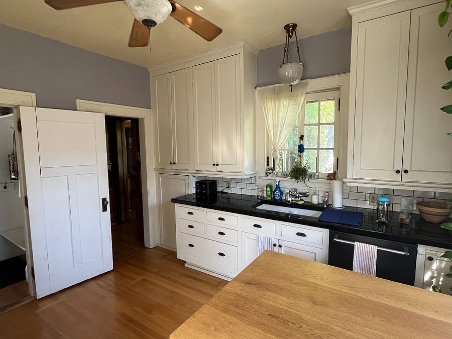 Sunny, functional kitchen with views of the backyard
