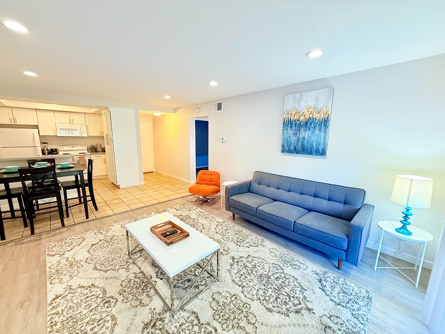 Living room with relaxing seating and a 75" Smart TV with Spectrum TV Subscription included