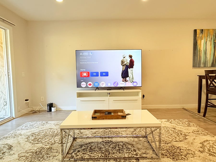 Living room with relaxing seating and a 75" Smart TV with Spectrum TV Subscription included