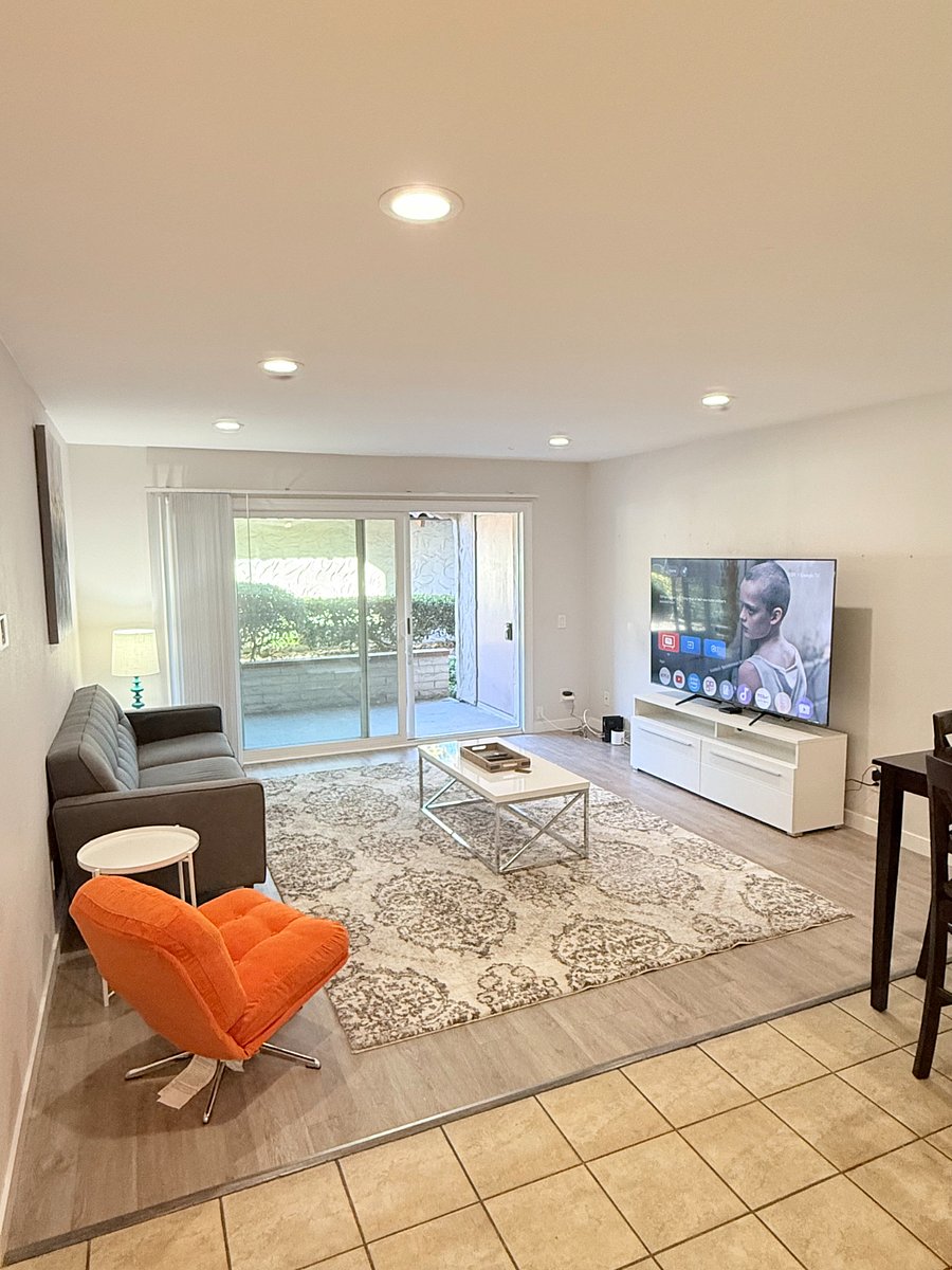 Living room with relaxing seating and a 75" Smart TV with Spectrum TV Subscription included
