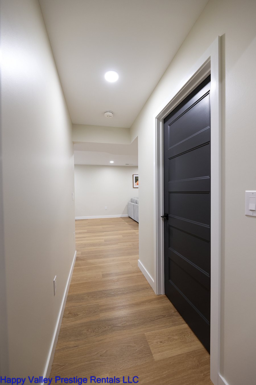 Downstairs hall with a door to the bathroom and Rec room