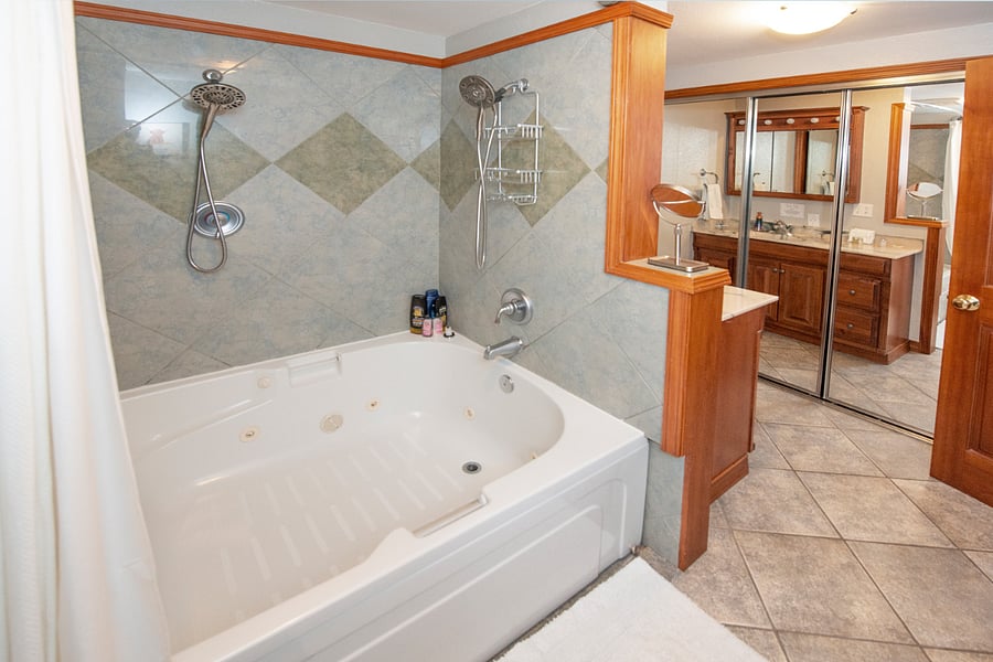 Master bathroom boasts a double size jacuzzi tub for relaxing and soaking