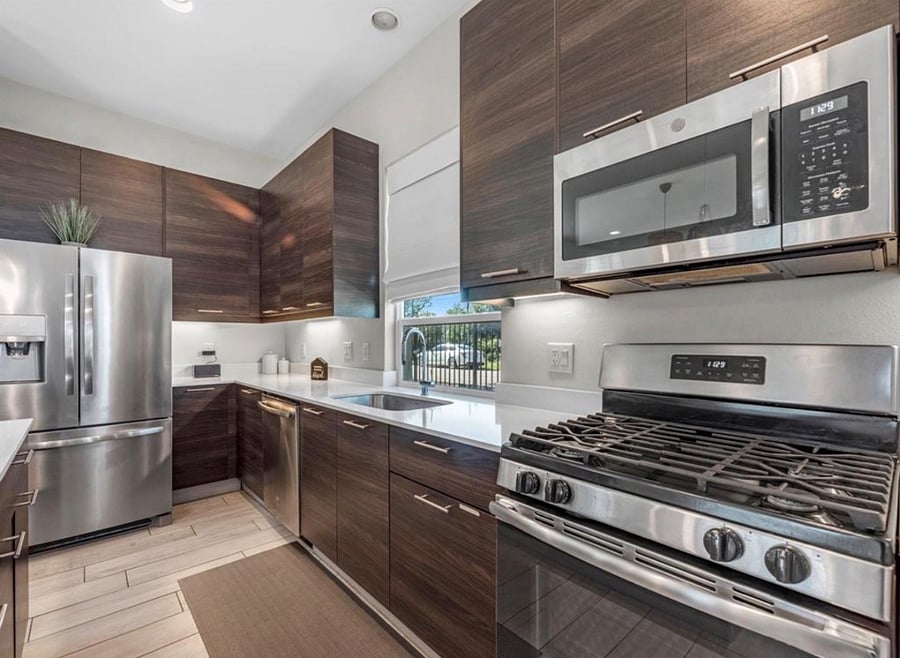 Full kitchen with stainless steel appliances.