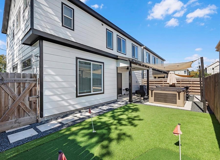 Artificial grass in the back with putting green. 