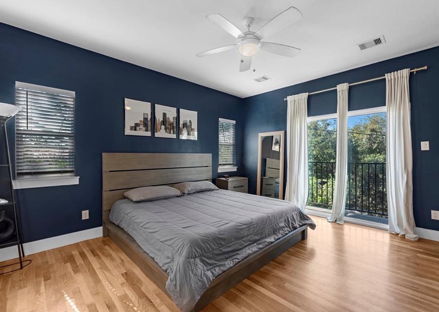 Large Master Bedroom with king size bed and large TV. Access to a balcony overlooking the street as well. 