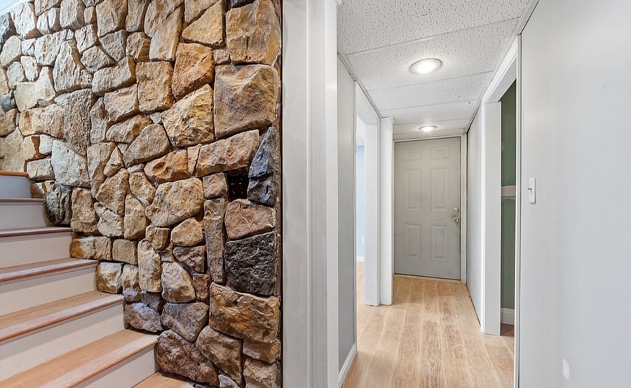 Wife and bright hallway leading to bedroom, Bathroom and Laundry room right across the bedroom