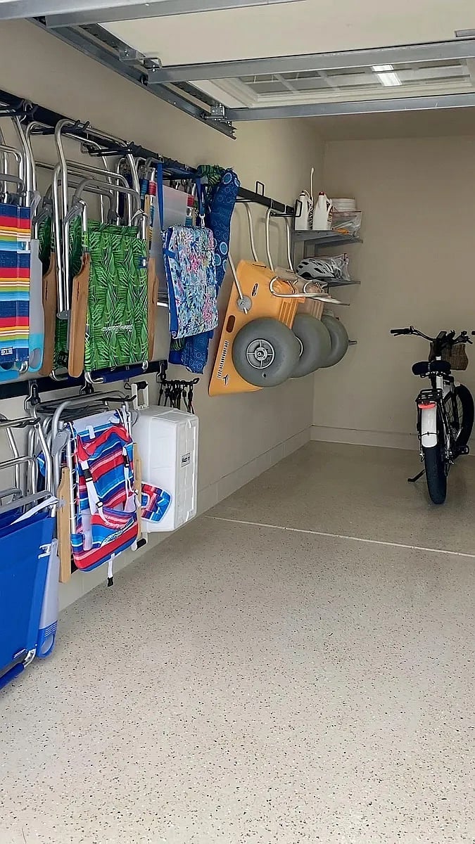 Garage with beach chairs and buggy and four 7-speed bikes.