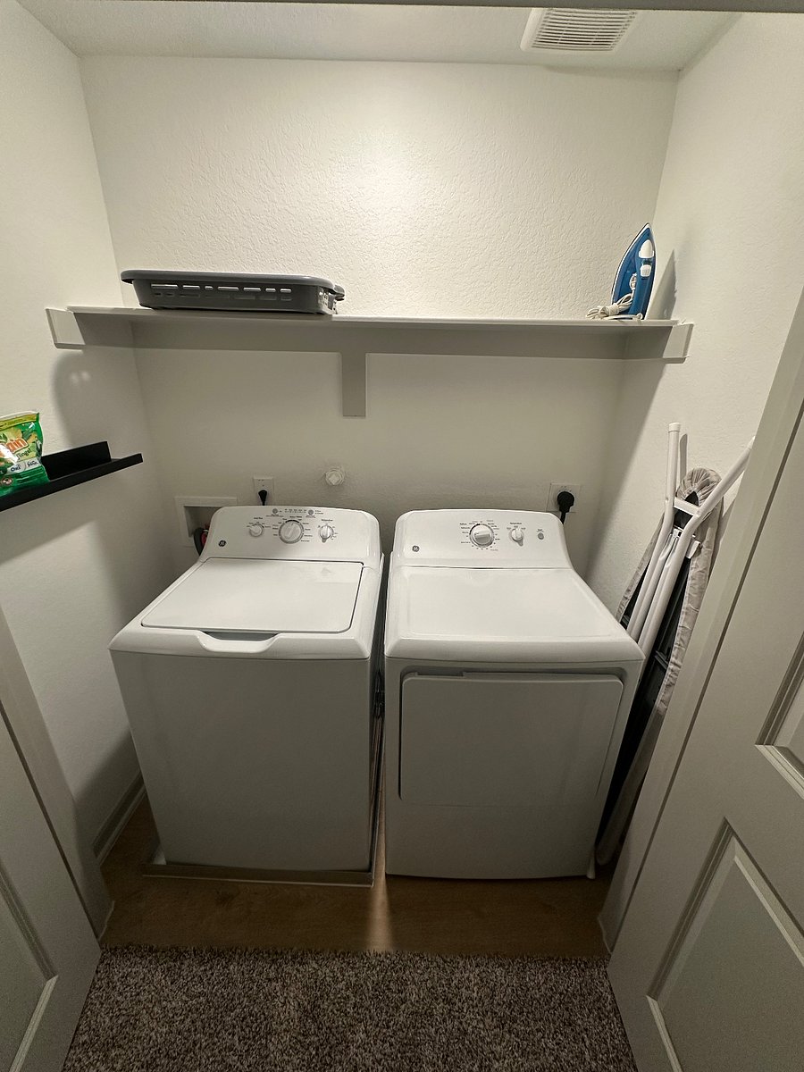 Washer/ dryer, iron, ironing board, and a collapsable laundry basket are located between the middle and last bedroom.