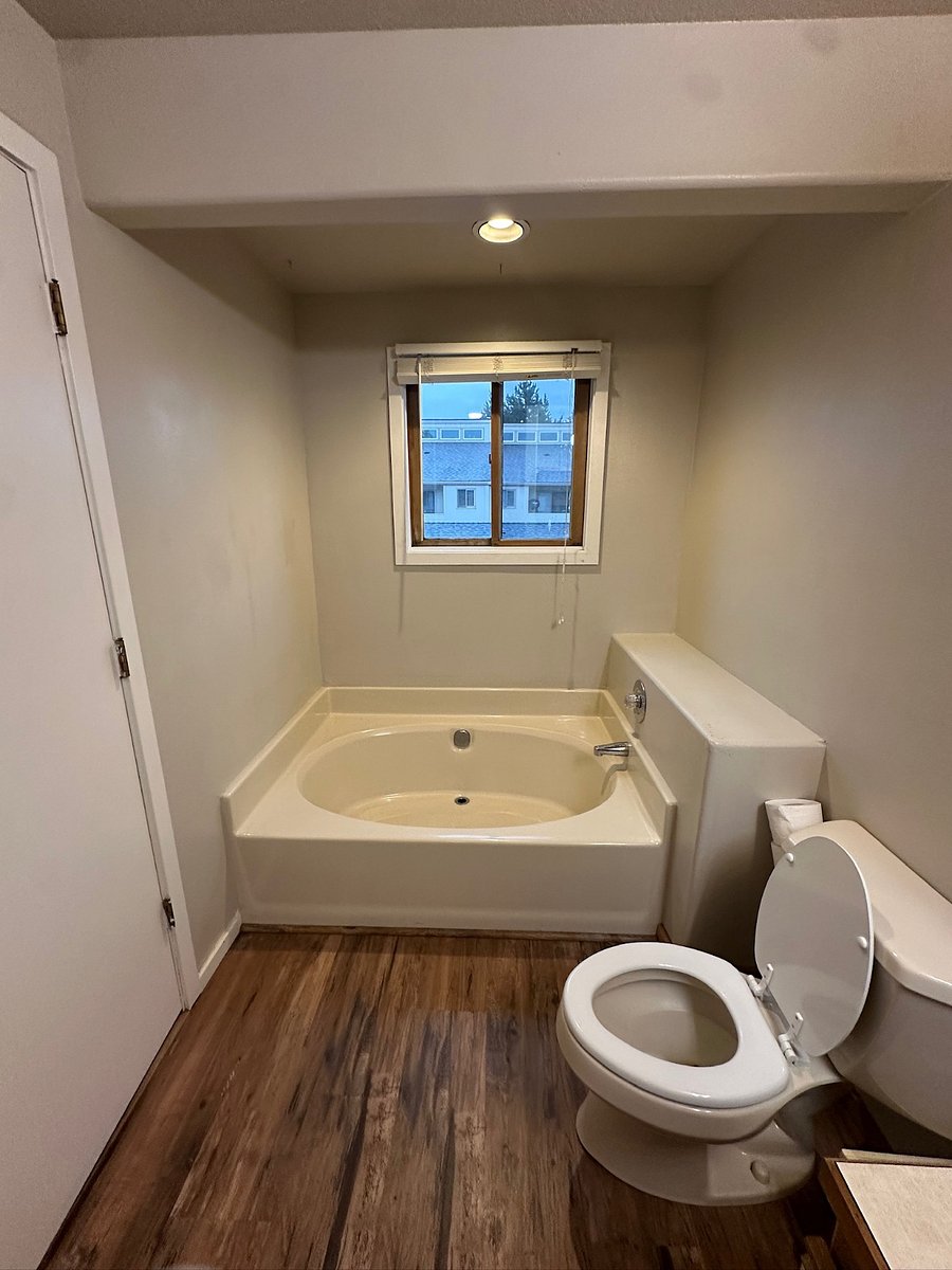 One of two master bathrooms, with window