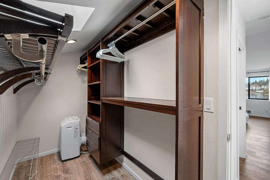 Walk in closet in upper suite.