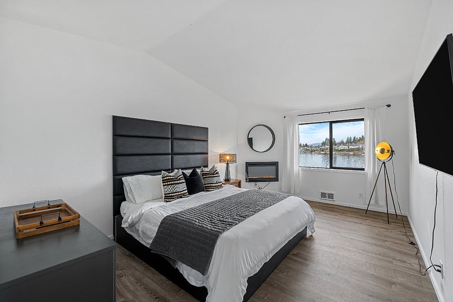 Main Bedroom upstairs with water views, fireplace, private bathroom and walk in closet.