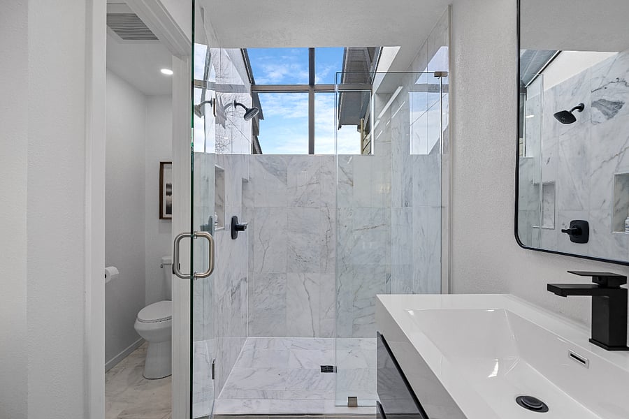 Private toilet, luxury shower with glass enclosure.