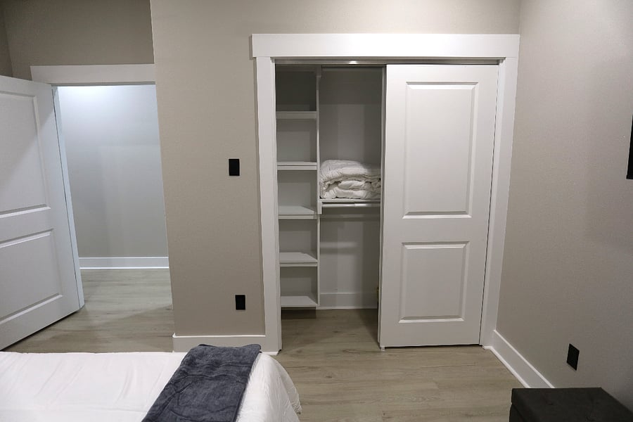 The Gray Escape offers ample closet space, plush blankets and pillowsblending comfort and boho-modern charm for a peaceful nights sleep.