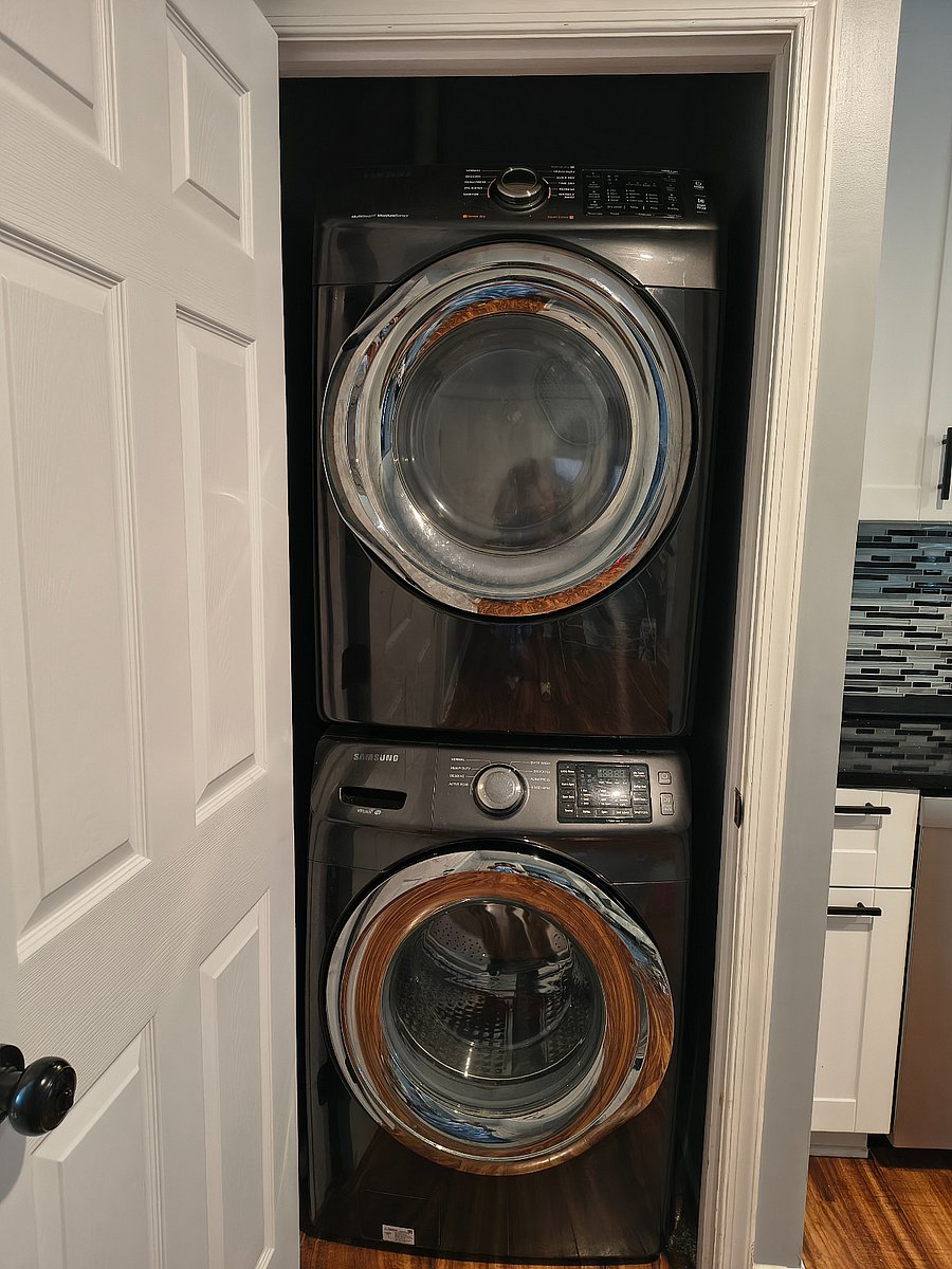 stacked washer/dryer unit in closet located in kitchen on first level.