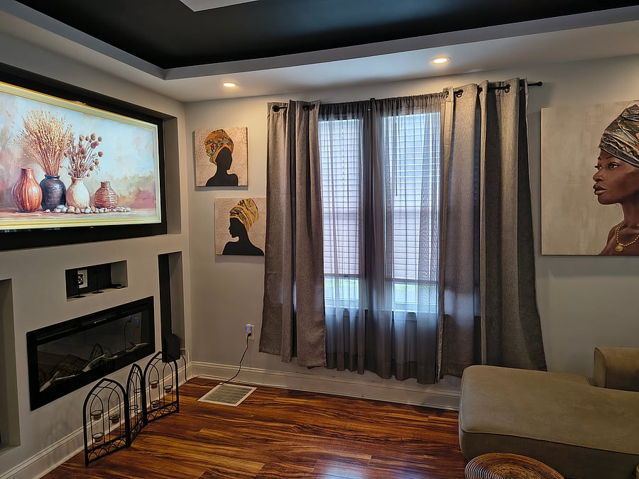 Living room with electric fireplace and flat screen television.