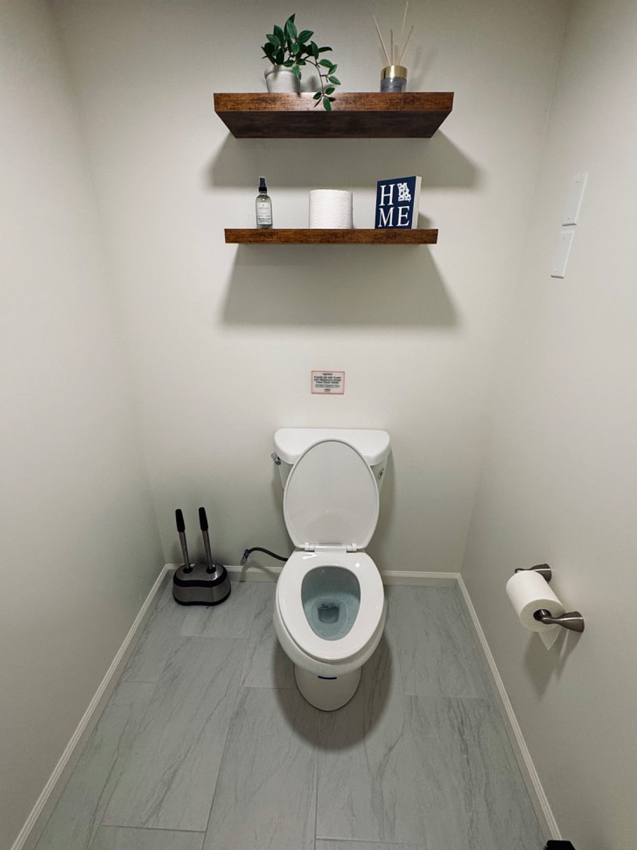 Separate toilet closet in wet room area.