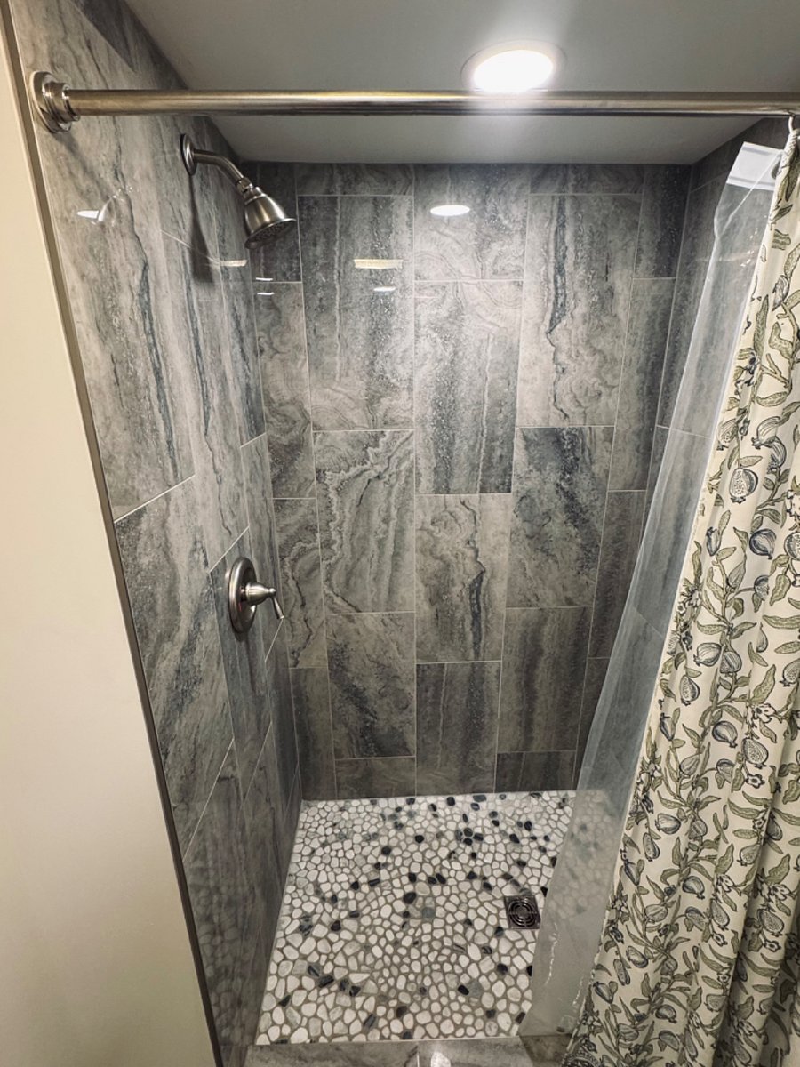 Separate walk-in shower located in wet room area.