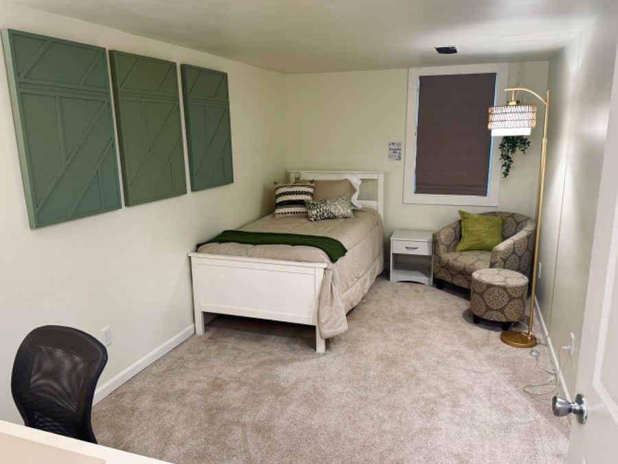 Gateway Bedroom (photo 1) with nightstand, closet, hangers, desk, comfy chair and dresser. Interior closet organizer with shelving. Egress window emergency exit. Mirrored closet doors. Twin bed. Blackout curtains.