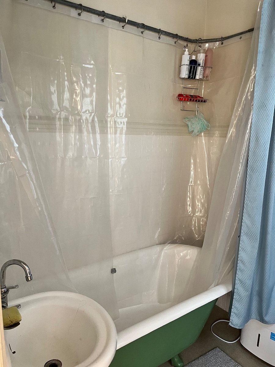 Another angle of the shower room with the large clawfoot tub.