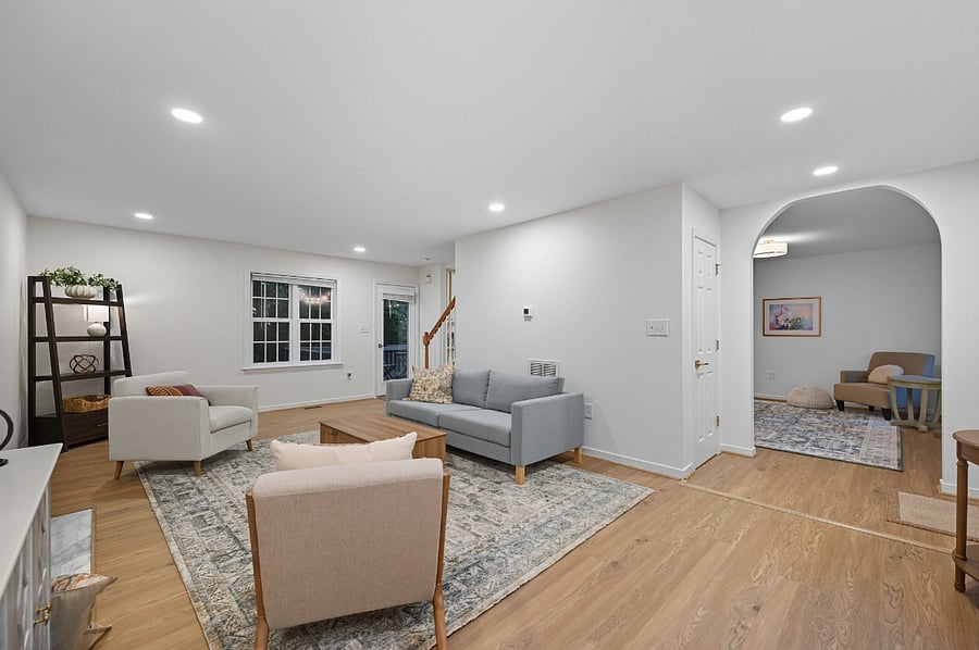 Comfortable living room with sofa, armchairs, fireplace, and smart TV. Designed for relaxation after long shifts or workdays.