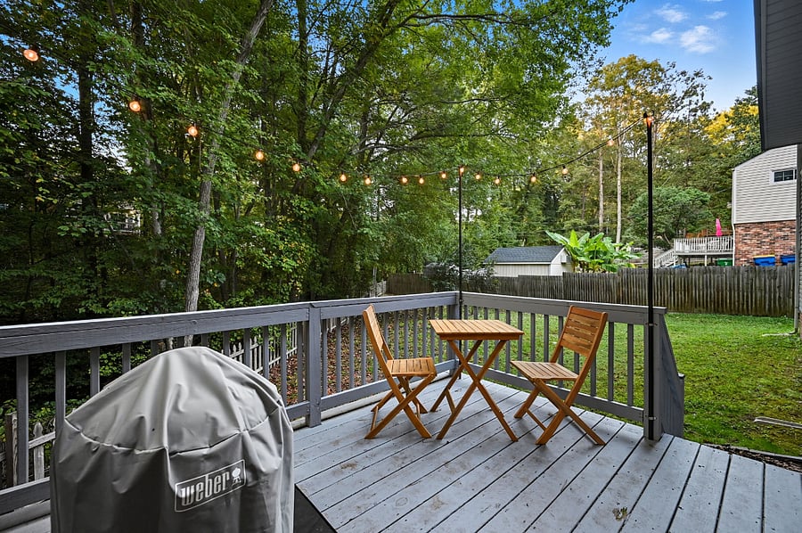 Back deck with grill and wooded views. Relaxing outdoor space during your assignment.