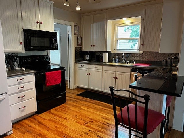 view of kitchen with eat at bar in forefront