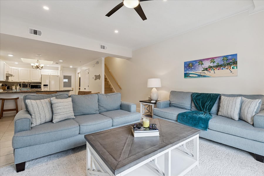 Spacious living room with coastal hues and plush seating for total comfort.
