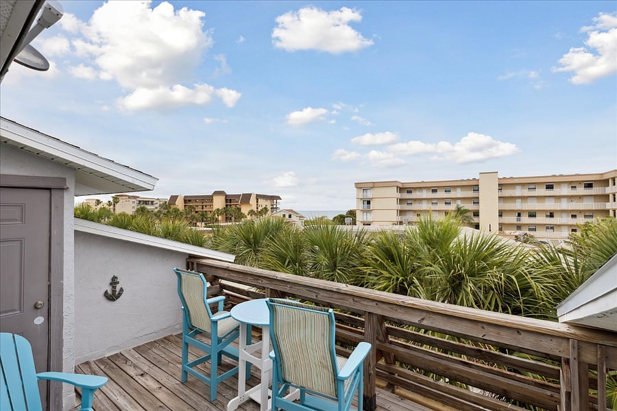 Private balcony with ocean views and cozy seating to soak in the sea breeze.